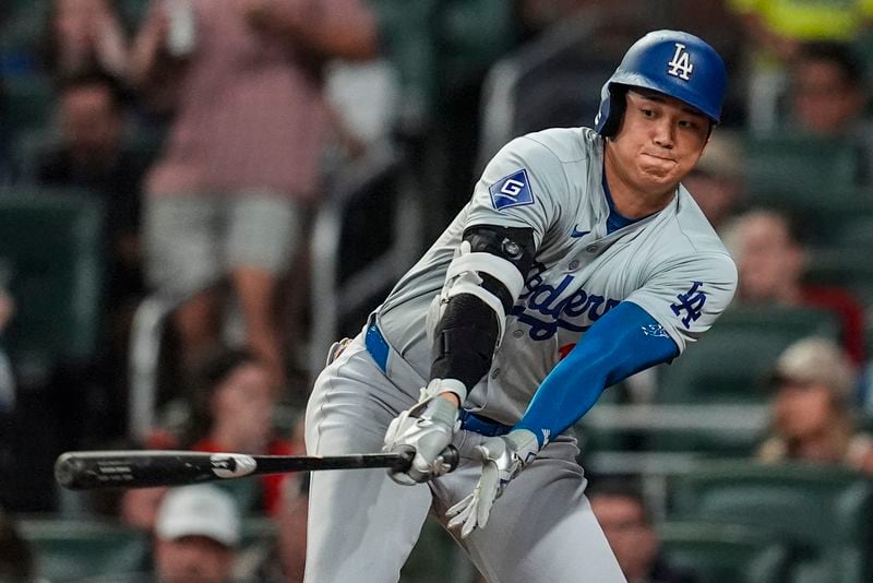 Los Angeles Dodgers two-way player Shohei Ohtani (17) stikes out in the third inning of a baseball game against the Atlanta Braves, Friday, Sept. 13, 2024, in Atlanta. (AP Photo/Mike Stewart)