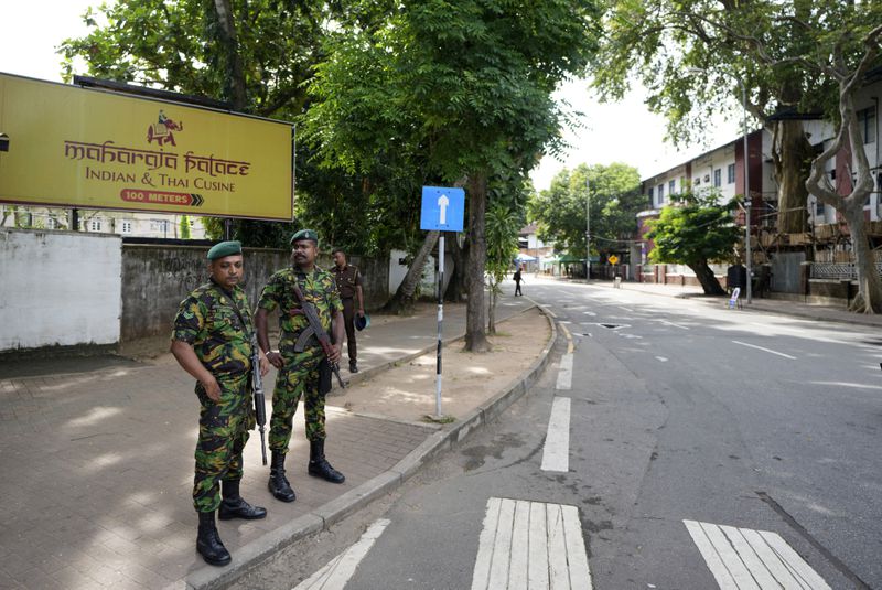 Police commandos stand guard, as a countrywide curfew was imposed then, outside a ballot counting center during the presidential election in Colombo, Sri Lanka, Sunday, Sept. 22, 2024. (AP Photo/Rajesh Kumar Singh)