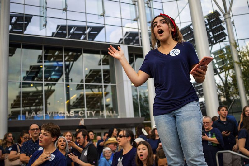 Members of The Church of Jesus Christ of Latter-day Saints sing outside Las Vegas City Hall as officials consider the church's plans to build a new temple near Las Vegas, May 14, 2024. (AP Photo/Ty ONeil)