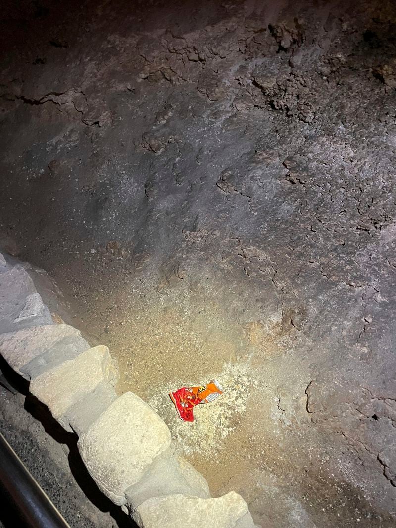 This undated photo provided by Carlsbad Caverns National Park shows a bag of Cheetos that was dropped off trail by a visitor in the Big Room at the national park near Carlsbad, N.M.(Carlsbad Caverns National Park via AP)