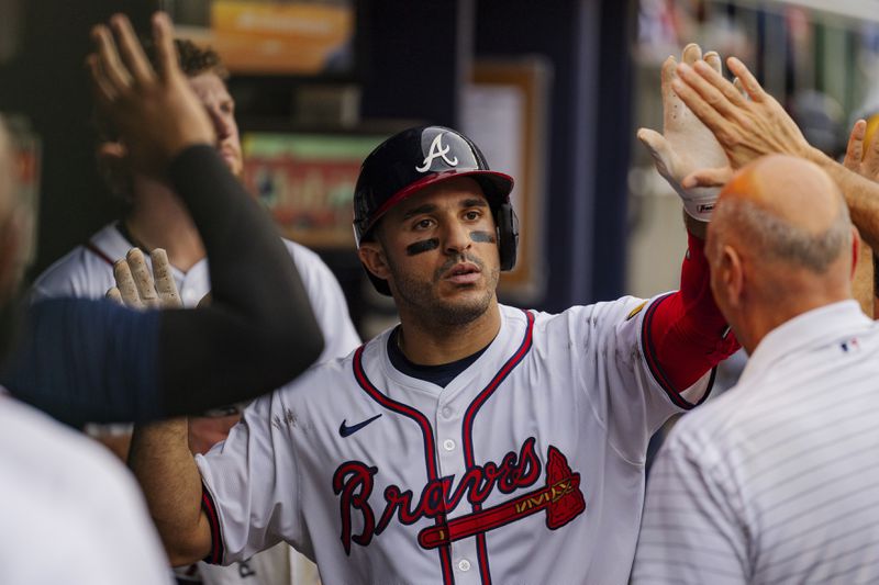 Atlanta Braves' Ramon Laureano, center, celebrates with teammates in the dugout after hitting a solo home run to centerfield in the sixth inning of a baseball game against the New York Mets, Monday, Sept. 30, 2024, in Atlanta. (AP Photo/Jason Allen)