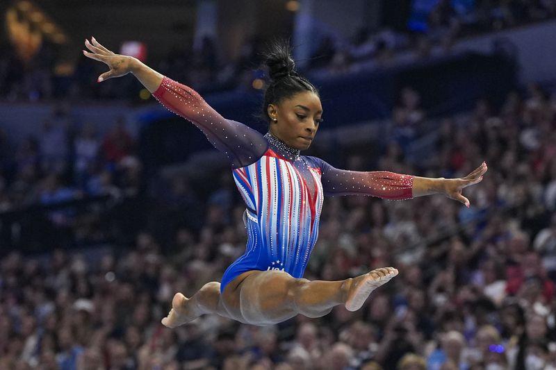 Simone Biles competes on the balance beam at the United States Gymnastics Olympic Trials on Sunday, June 30, 2024, in Minneapolis. (AP Photo/Abbie Parr)