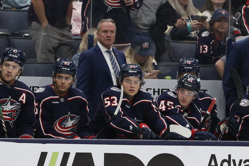 Columbus Blue Jackets head coach Dean Evason watches his team play against the St. Louis Blues during the third period of a preseason NHL preseason hockey game Wednesday, Sept. 25, 2024, in Columbus, Ohio. (AP Photo/Jay LaPrete)