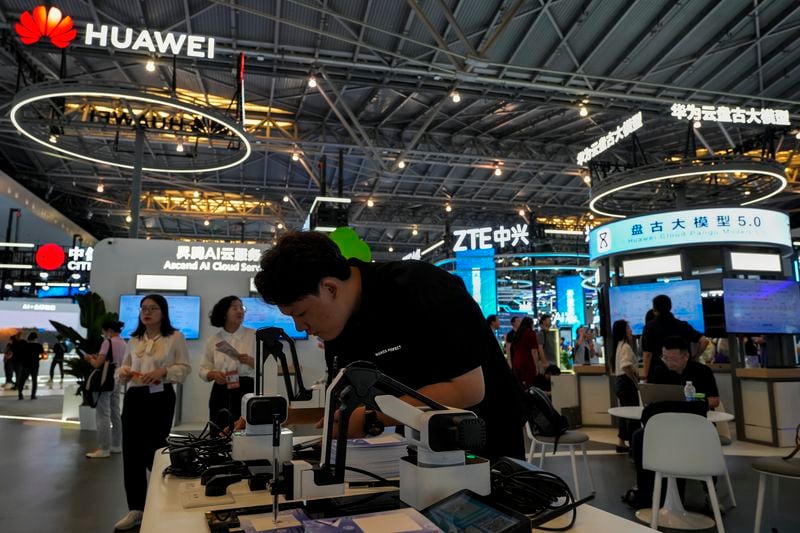 Visitors tour the Huawei and ZTE exhibition booths during the 2024 World Artificial Intelligence Conference (WAIC) & High-Level Meeting on Global AI Governance with the themed "Governing AI for Good and for All" at the Shanghai Expo Center Multifunction Hall in Shanghai, China on July 4, 2024. Germany will bar the use of components made by Chinese companies Huawei and ZTE from core parts of the country's 5G networks, in two steps starting in 2026, the nation's top security official said Thursday, July 11, 2024. (AP Photo/Andy Wong)