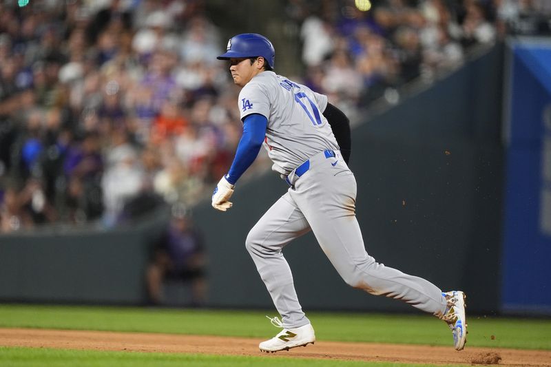 Los Angeles Dodgers' Shohei Ohtani advances from second base to third base on a sacrifice fly hit by Chris Taylor in the sixth inning of a baseball game against the Colorado Rockies Saturday, Sept. 28, 2024, in Denver. (AP Photo/David Zalubowski)