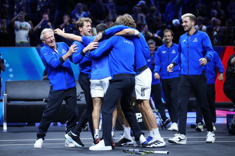 Team Europe's Carlos Alcaraz celebrates with teammates after winning against Team World's Taylor Fritz on the third day of the Laver Cup tennis tournament, at the Uber arena in Berlin, Germany, Sunday, Sept. 22, 2024. (AP Photo/Ebrahim Noroozi)