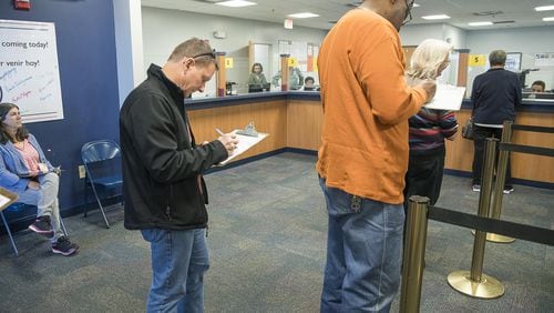 Gwinnett County residents fill out paperwork before casting their ballot during early voting for the county’s MARTA referendum at the Board of Voter Registrations and Elections building in Lawrenceville on Feb. 25. (ALYSSA POINTER/ALYSSA.POINTER@AJC.COM)