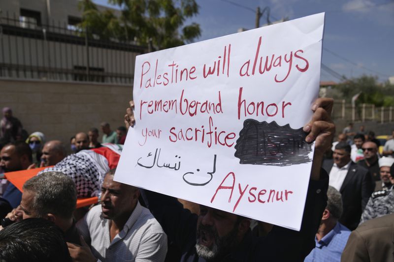 Mourners carry the body of Aysenur Ezgi Eygi, 26, who was fatally shot by Israeli soldiers while participating in an anti-settlement protest in the West Bank, during her funeral procession in the West Bank city of Nablus, Monday, Sept. 9, 2024. (AP Photo/Nasser Nasser)