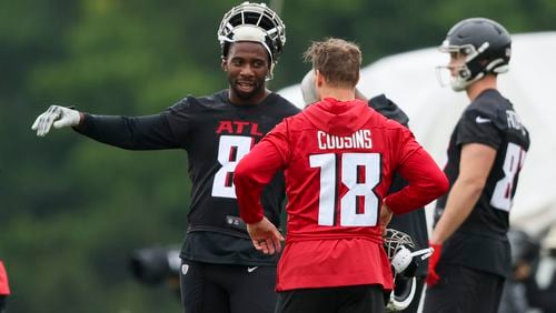 Atlanta Falcons quarterback Kirk Cousins (18) talks with tight end Kyle Pitts (8) during minicamp at the Atlanta Falcons Training Camp, Tuesday, May 14, 2024, in Flowery Branch, Ga. (Jason Getz / AJC)
