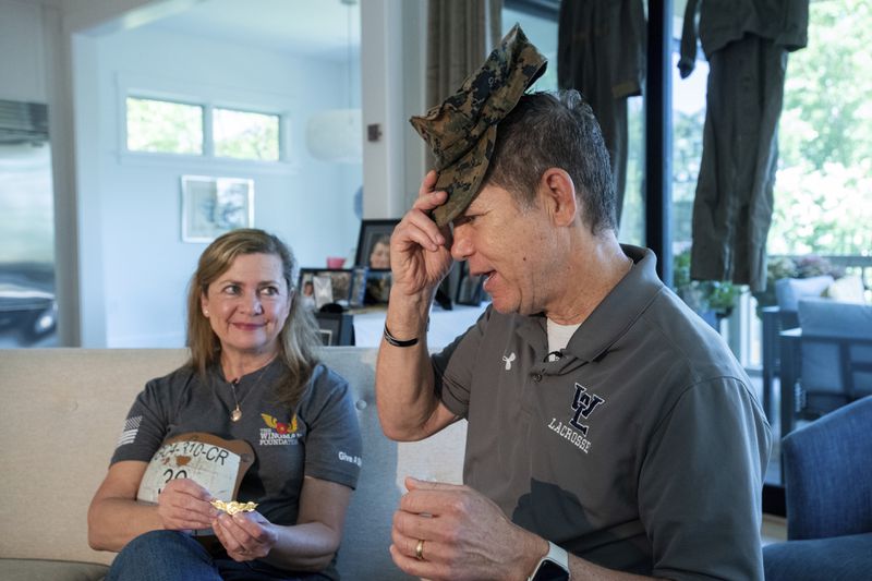 Bart Collart, right, and his wife Alexia Collart, talk about their son, Marine Corporal Spencer R. Collart, at their home, in Arlington, Va., Thursday, June 19, 2024. Their son was killed along with two other Marines when the MV-22B Osprey aircraft they were on crashed during drills on a north Australian island on August 27, 2023. (AP Photo/Rod Lamkey, Jr.)