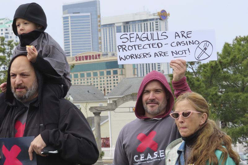 Family members of casino dealers attend a rally urging the city to eliminate smoking in casinos, April 12, 2022, in Atlantic City, N.J. (AP Photo/Wayne Parry)