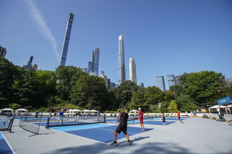 People practice pickleball on the courts of CityPickle at Central Park's Wollman Rink, Saturday, Aug. 24, 2024, in New York. (AP Photo/Eduardo Munoz Alvarez)