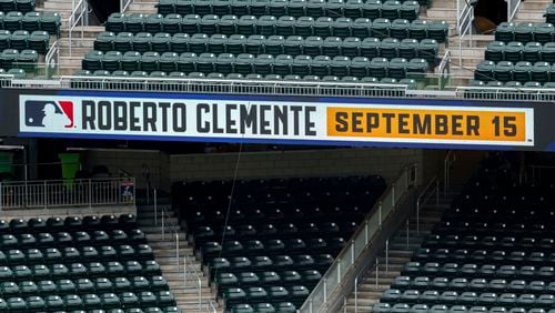 Signage in right field of Truist Park showing the commemorative day celebrating Roberto Clemente before a baseball game between the Los Angeles Dodgers and the Atlanta Braves, Sunday, Sept. 15, 2024, in Atlanta. (AP Photo/Jason Allen)