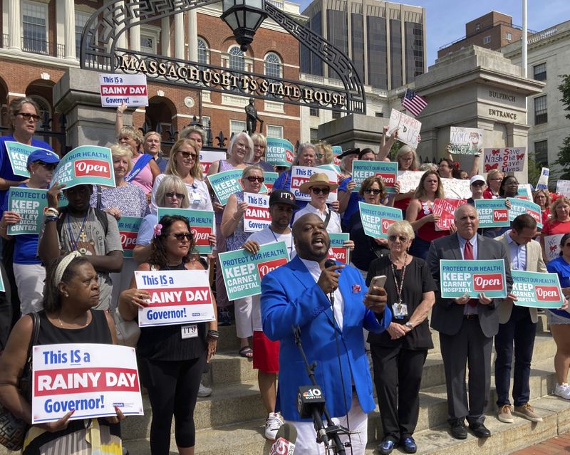 Protesters wanting to keep two Massachusetts hospitals open gather in front of the statehouse in Boston on Wednesday, Aug. 28, 2024. (AP Photo/Steve LeBlanc)