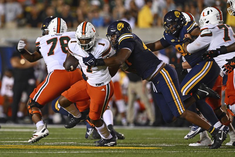 California linebacker Xavier Carlton (44) sacks Miami quarterback Cam Ward (1) during the second quarter of their game at Memorial Stadium in Berkeley, Calif., on Saturday, Oct. 5, 2024. (Jose Carlos Fajardo/Bay Area News Group via AP)