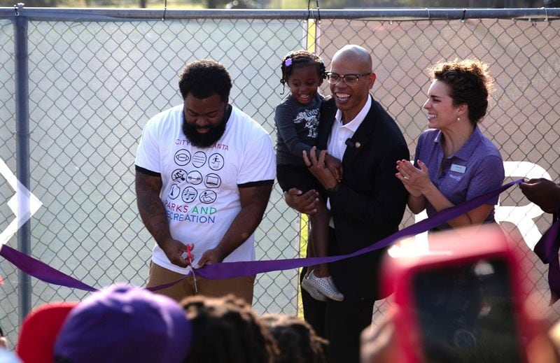 Atlanta City Councilman Jason Dozier and his daughter (center) celebrate upgrades made to Rosa L. Burney Park in Mechanicsville in 2023.