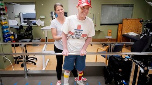 Physical therapist Kim Noha works with Paul Nolan at Courage Kenny Rehabilitation Institute in Golden Valley on June 18, 2018. Nolan was one of the most popular jockeys at Canterbury Park. Now the Bloomington resident is learning to walk again after a serious racing accident last year in Oklahoma that damaged his spinal cord and left him paralyzed. (Carlos Gonzalez/Minneapolis Star Tribune/TNS)