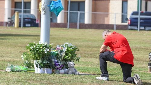 Mourners pay tribute to Apalachee High School shooting victims. (John Spink/The Atlanta Journal-Constitution)