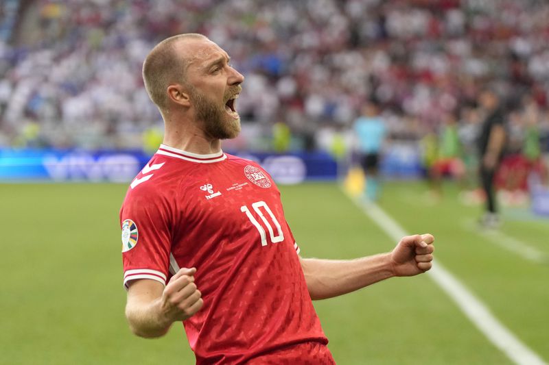 Denmark's Christian Eriksen celebrates after scoring the opening goal of the game during a Group C match between Slovenia and Denmark at the Euro 2024 soccer tournament in Stuttgart, Germany, Sunday, June 16, 2024. (AP Photo/Matthias Schrader)