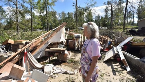 Sharon Granade stands on destroyed two-car garage after Tropical Storm Michael passed in Roberta, Ga., on Oct. 11, 2018. Tropical Storm Michael swept out of Georgia before sunrise that day, leaving a trail of destruction in its wake. HYOSUB SHIN / HSHIN@AJC.COM