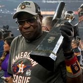 Houston Astros manager Dusty Baker Jr. holds the trophy after their win against the Boston Red Sox in Game 6 of baseball's American League Championship Series Friday, Oct. 22, 2021, in Houston. The Astros won 5-0, to win the ALCS series in game six. (Tony Gutierrez/AP)