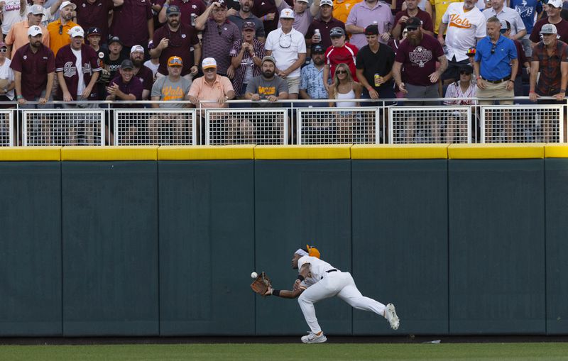 Tennessee's Kavares Tears catches a fly ball hit by Texas A&M's Ted Burton during the fourth inning of Game 1 of the NCAA College World Series baseball finals in Omaha, Neb., Saturday, June 22, 2024. (AP Photo/Rebecca S. Gratz)