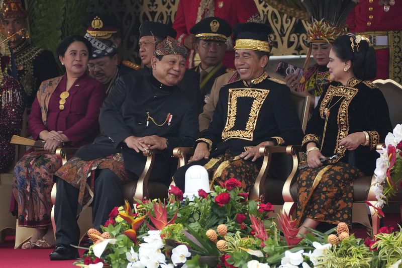 Indonesian President Joko Widodo, second right, and his wife Iriana, right, confer with Defense Minister and president-elect Prabowo Subianto, second left, as House Speaker Puyan Maharani, left, looks on during the ceremony marking Indonesia's 79th anniversary of independence at the new presidential palace in its future capital of Nusantara, a city still under construction on the island of Borneo, Saturday, Aug. 17, 2024. (AP Photo/Achmad Ibrahim)