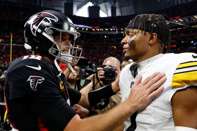 Atlanta Falcons quarterback Kirk Cousins, left, and Pittsburgh Steelers quarterback Justin Fields meet after the Steelers won the NFL football game Sunday, Sept. 8, 2024, in Atlanta. (AP Photo/Butch Dill)