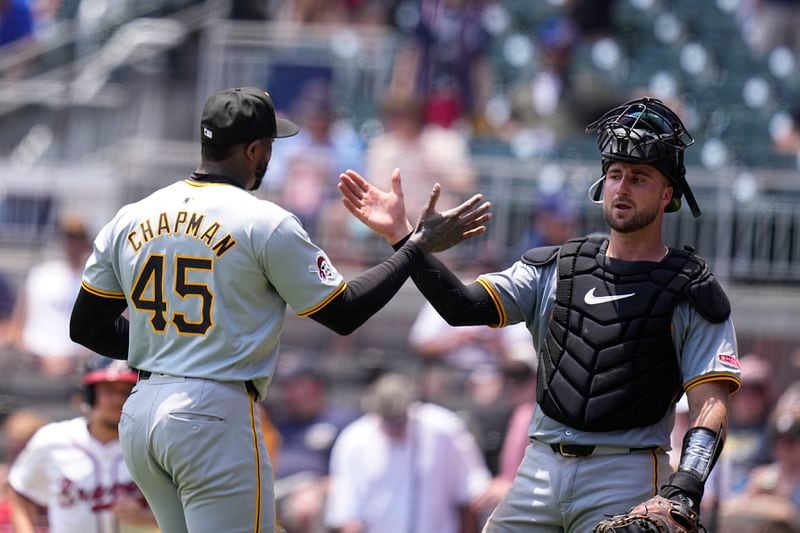 Pittsburgh Pirates catcher Joey Bart, right, and pitcher Aroldis Chapman (45) celebrate a win against the Atlanta Braves after a baseball game, Sunday, June 30, 2024, in Atlanta. (AP Photo/Brynn Anderson)
