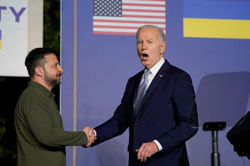 President Joe Biden answers no to a question about pardoning his son as he shakes hands with Ukrainian President Volodymyr Zelenskyy after signing a bilateral security agreement on the sidelines of the G7, Thursday, June 13, 2024, in Savelletri, Italy. (AP Photo/Alex Brandon)