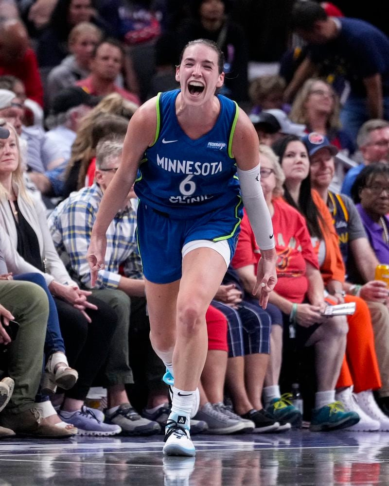 Minnesota Lynx forward Bridget Carleton (6) celebrates after a three-point basket against the Indiana Fever in the second half of a WNBA basketball game in Indianapolis, Friday, Sept. 6, 2024. (AP Photo/Michael Conroy)