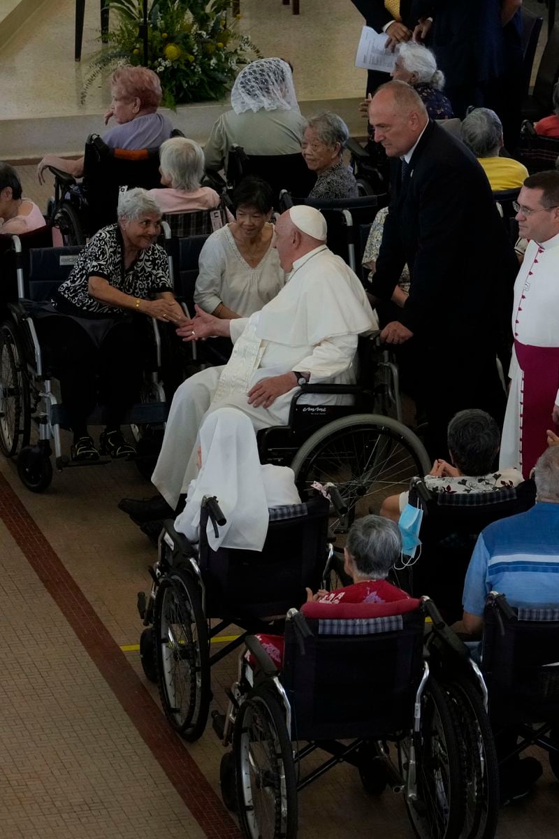 Pope Francis meets with a group of elderly and sick people at the St. Theresa's Home in Singapore, Friday, Sept. 13, 2024. Pope Francis is wrapping up his visit to Singapore by praising its tradition of interfaith harmony. (AP Photo/Gregorio Borgia)