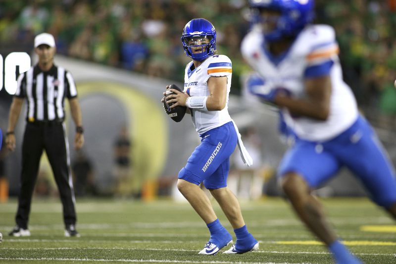 Boise State quarterback Maddux Madsen (4) looks for an open pass during the first half of an NCAA college football game against Oregon, Saturday, Sept. 7, 2024, at Autzen Stadium in Eugene, Ore. (AP Photo/Lydia Ely)