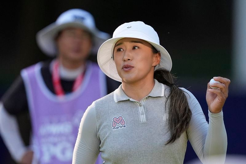 Amy Yang, of South Korea, holds her ball after finishing the 18th hole, her last of the day, during the second round of the Women's PGA Championship golf tournament at Sahalee Country Club, Friday, June 21, 2024, in Sammamish, Wash. (AP Photo/Gerald Herbert)