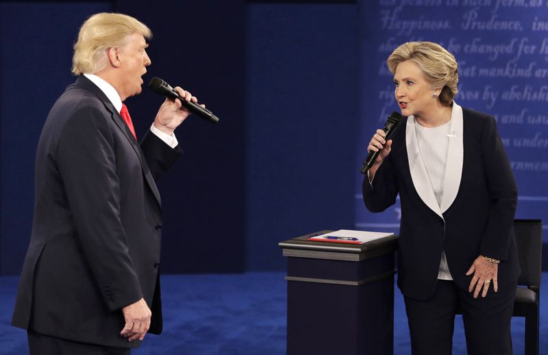 FILE - Republican presidential nominee Donald Trump, left, and Democratic presidential nominee Hillary Clinton speak during the second presidential debate in St. Louis, Oct. 9, 2016. (AP Photo/John Locher, File)