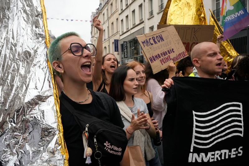 Demonstrators shout slogans during a protest, responding to a call from the far-left party who criticized as a power grab the president's appointment of a conservative new prime minister, Michel Barnier, in Paris, France, Saturday, Sept. 7, 2024. (AP Photo/Michel Euler)