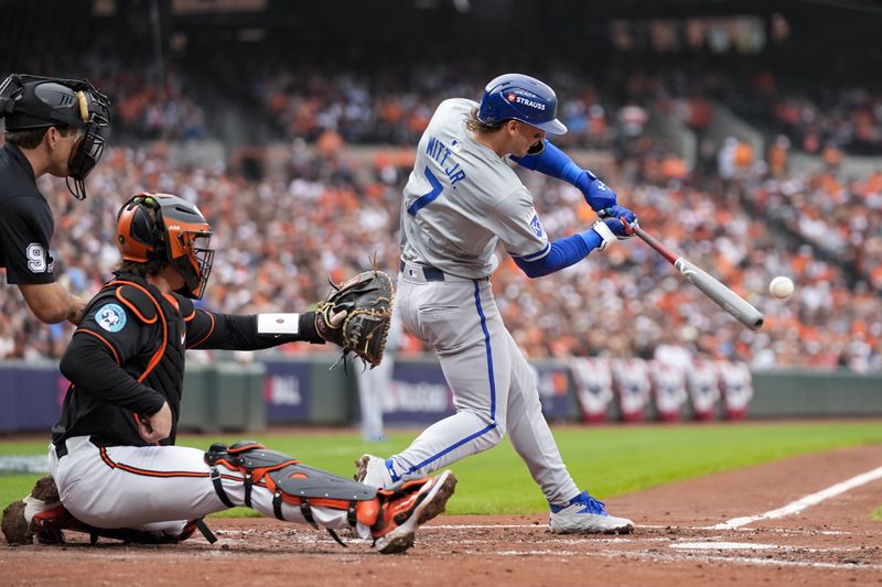 Kansas City Royals' Bobby Witt Jr. (7) hits a single as home plate umpire Ben May, left, and Baltimore Orioles catcher Adley Rutschman look on during the third inning in Game 2 of an AL Wild Card Series baseball game, Wednesday, Oct. 2, 2024 in Baltimore. (AP Photo/Stephanie Scarbrough)