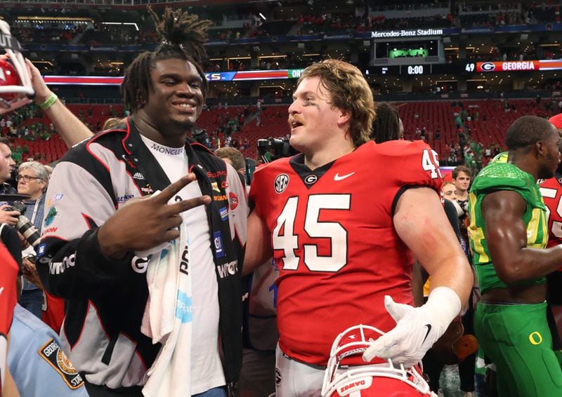 Former Georgia Bulldogs Jordan Davis celebrates with Georgia Bulldogs defensive lineman Bill Norton (45) after their 49-3 win against the Oregon Ducks in the Chick-fil-A Kickoff game at Mercedes Benz Stadium, Saturday, September 3, 2022, in Atlanta. (Jason Getz / Jason.Getz@ajc.com)