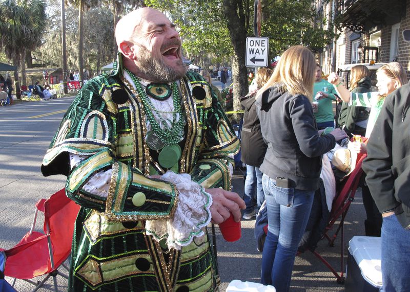 Brian Welzenbach laughs with friends on St. Patrick's Day in 2017 in Savannah. The coastal city has been celebrating the Irish holiday since 1824, and now thousands come each year for one of the South's largest street parties after Mardi Gras. (AP Photo/Russ Bynum)