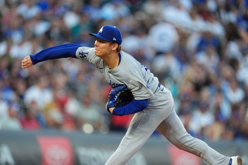 Los Angeles Dodgers starting pitcher Yoshinobu Yamamoto works agianst the Colorado Rockies in the first inning of a baseball game, Saturday, Sept. 28, 2024, in Denver. (AP Photo/David Zalubowski)