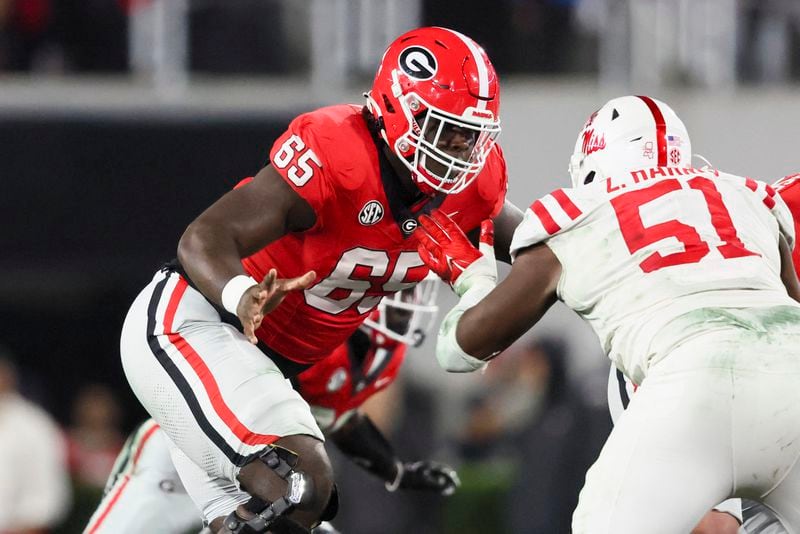 Georgia offensive lineman Amarius Mims (65) blocks Mississippi defensive tackle Zxavian Harris (51) during their game at Sanford Stadium, Saturday, November 11, 2023, in Athens, Ga. Georgia won 52-17. (Jason Getz / Jason.Getz@ajc.com)