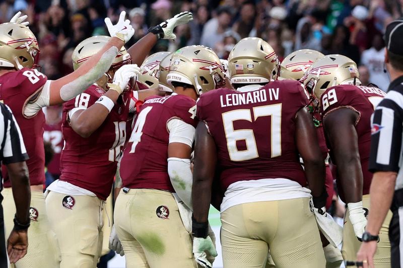 Florida players celebrate a touchdown during the NCAA college football game between Georgia Tech and Florida State at the Aviva stadium in Dublin, Saturday, Aug. 24, 2024. (AP Photo/Peter Morrison)