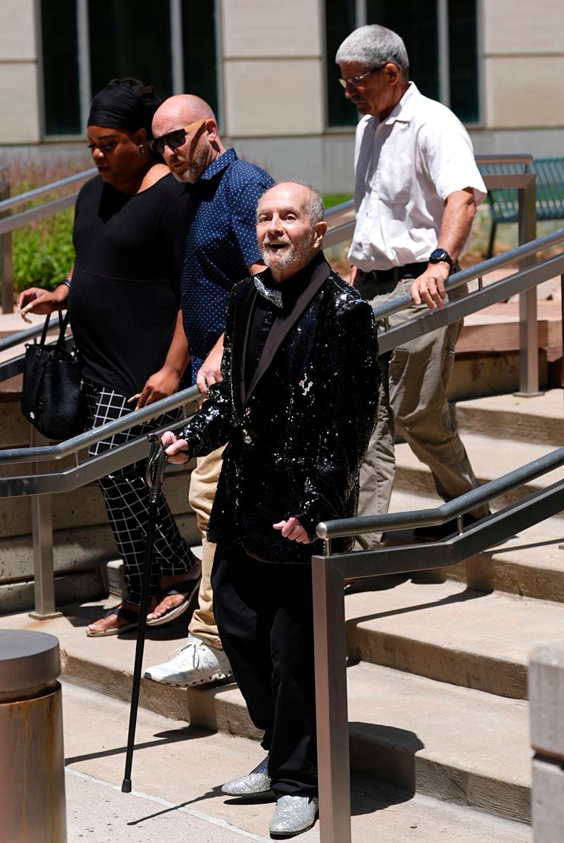 Ed Sanders, front, heads over to speak to reporters after the sentencing of the shooter who killed five people and injured 19 others at a Colorado Springs LGBTQ+ club, at a hearing Tuesday, June 18, 2024, in Denver. The shooter pleaded guilty to federal hate crime charges and was sentenced to 55 life terms in prison. (AP Photo/David Zalubowski)