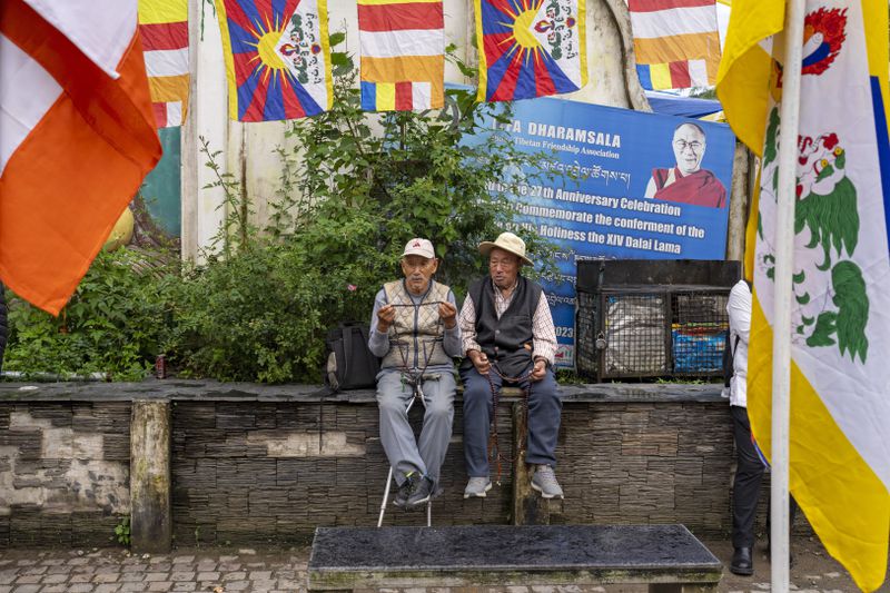 Two elderly exiled Tibetans wait to welcome their spiritual leader the Dalai Lama before he arrives in Dharamshala, India, Wednesday, Aug. 28, 2024. (AP Photo/Ashwini Bhatia)