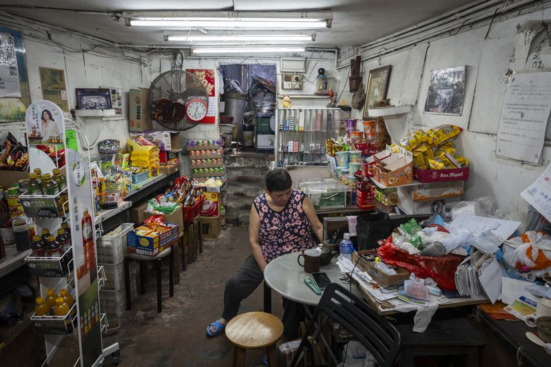 A villager tends her store at the Cha Kwo Ling village in east Kowloon, Hong Kong, Sunday, Aug. 25, 2024. (AP Photo/Chan Long Hei)