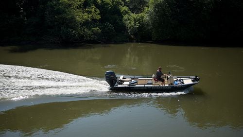 Chattahoochee Riverkeeper Executive Director Jason Ulseth scours the river for irregularities during a boat patrol ride with the organization on June 12. (Riley Bunch/AJC 2024)