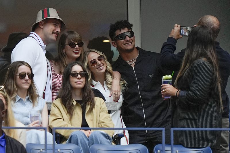 From left, Kansas City Chiefs tight end Travis Kelce, Taylor Swift, Brittany Mahomes and Kansas City Chiefs quarterback Patrick Mahomes pose for a photo while watching play between Jannik Sinner, of Italy, and Taylor Fritz, of the United States, during the men's singles final of the U.S. Open tennis championships, Sunday, Sept. 8, 2024, in New York. (AP Photo/Julia Nikhinson)