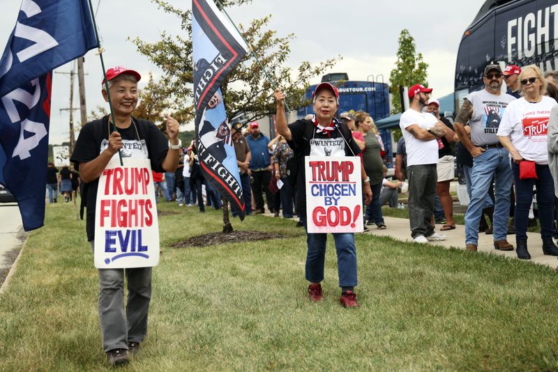 Katie Mimura, left, and Hisako Kaneko, center, who traveled from Japan to show support for Republican presidential nominee former President Donald Trump walk outside before a rally at Ed Fry Arena in Indiana, Pa., Monday, Sept. 23, 2024. (AP Photo/Rebecca Droke)