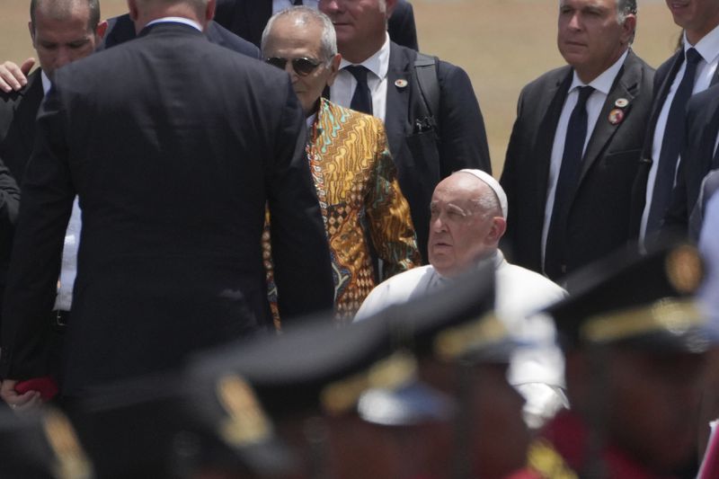 Pope Francis is accompanied by East Timor's President Jose Ramos-Horta to abroad a plane to Singapore at Nicolau Lobato International Airport in Dili, East Timor, Wednesday, Sept. 11, 2024. (AP Photo/Dita Alangkara)