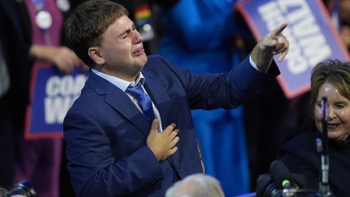 Gus Walz cries as his father Democratic vice presidential nominee Minnesota Gov. Tim Walz speaks during the Democratic National Convention Wednesday, Aug. 21, 2024, in Chicago. (AP Photo/Charles Rex Arbogast)